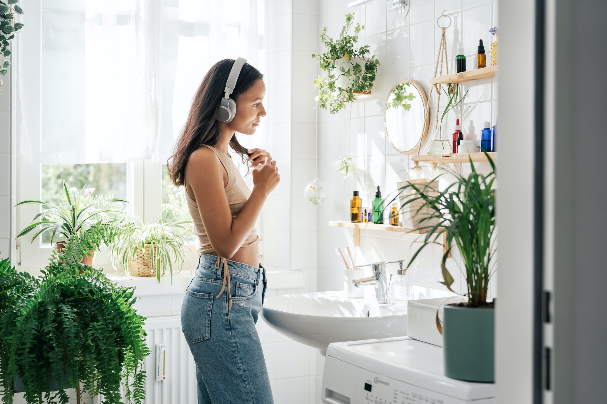 Young woman with headphones in bathroom